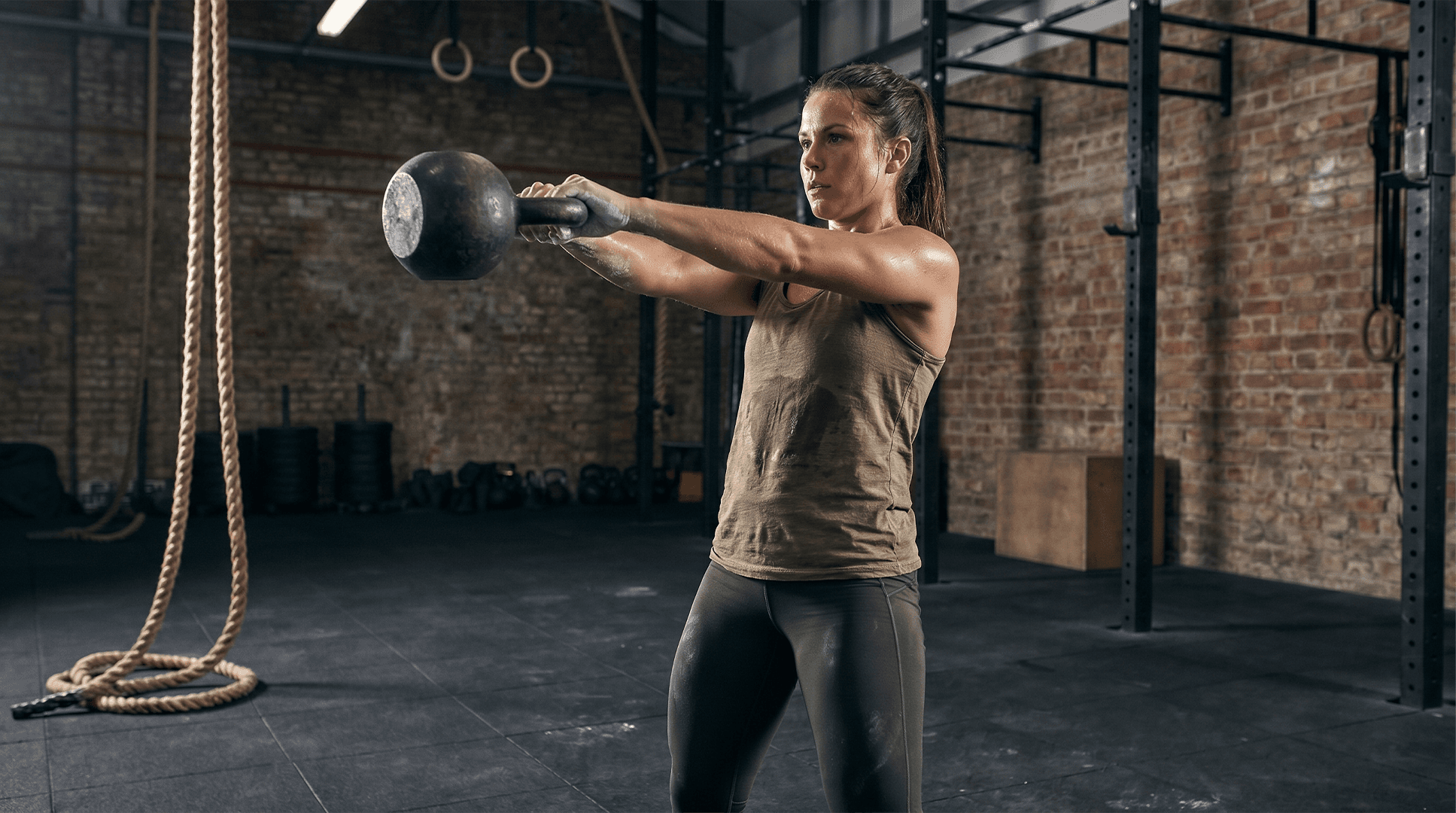 Woman performing kettlebell swings